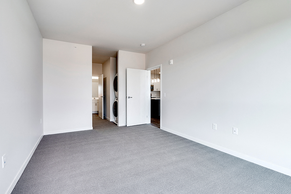 empty bedroom with gray carpet and white walls