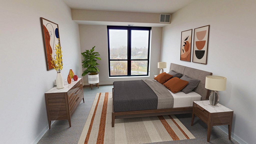 a bedroom with a bed and a large window