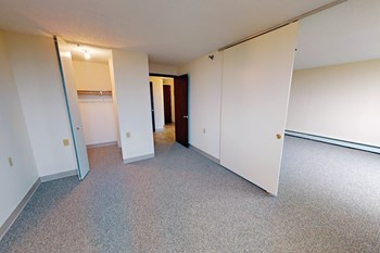 a bedroom with two closets and a door to a hallway