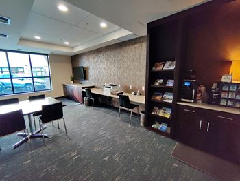 a conference room with a desk and a window