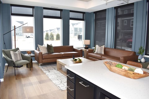 A living room with brown leather couches and a wooden coffee table.