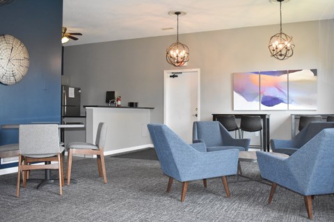 A modern living room with grey and blue chairs.