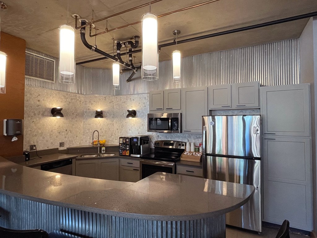 a kitchen with a large island and stainless steel appliances