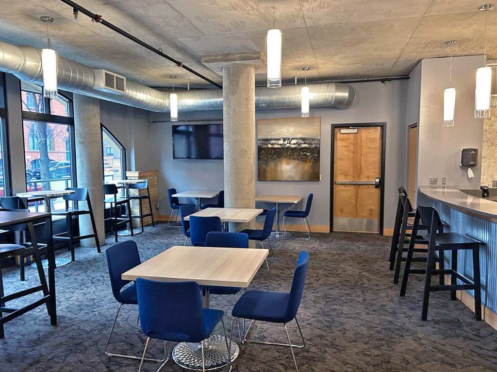 a dining room with tables and chairs and a tv