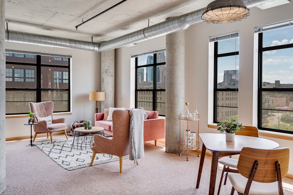Living room with large windows and a variety of seating