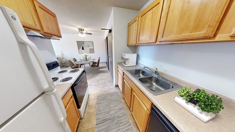 the view of a kitchen with a sink and a refrigerator