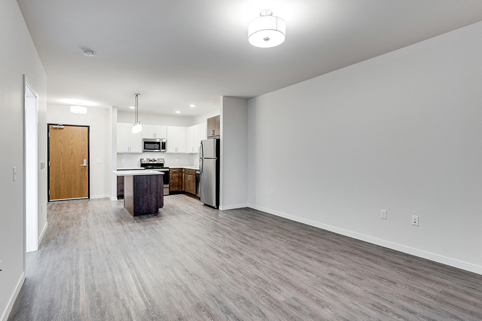 empty living room next to kitchen