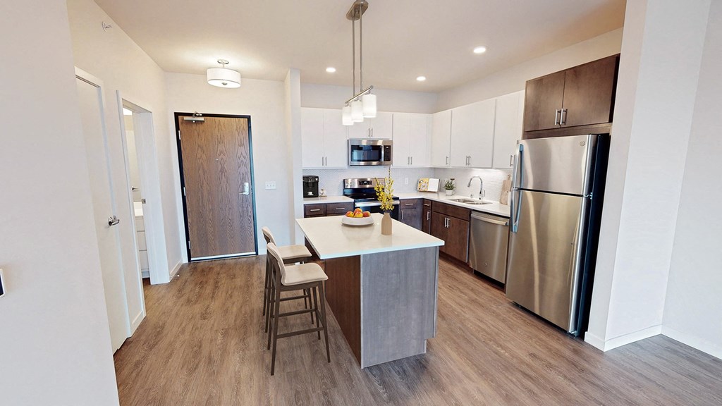 a kitchen with stainless steel appliances and a white counter top