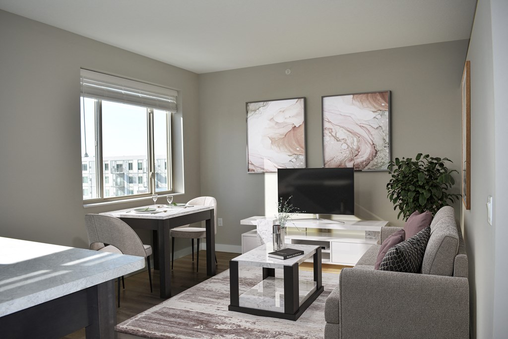 Spacious studio apartment living room with natural light flooding in through large windows.