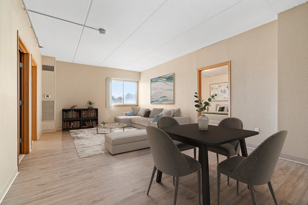 a living room and dining room with a table and chairs