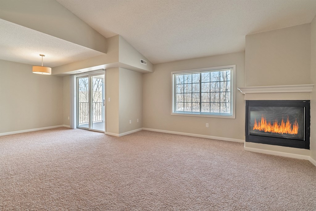 an empty living room with a fireplace
