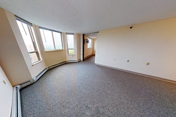 an empty room with three windows and a door