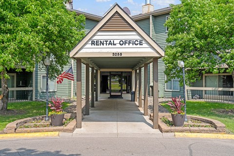 a rentals office with an american flag on the side of the road