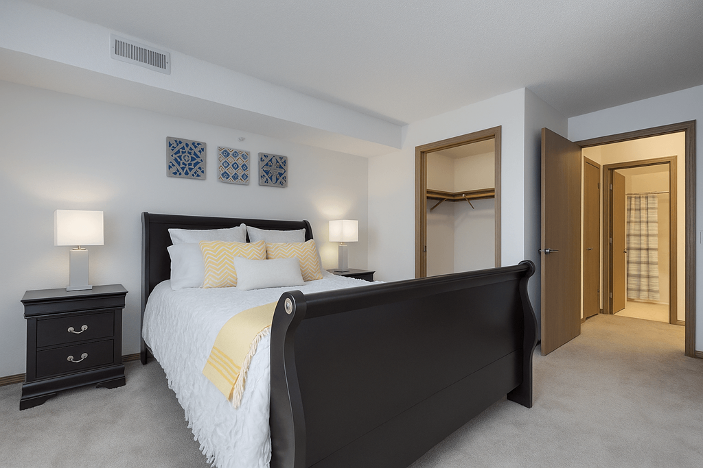 A bedroom with a large bed and a dresser.