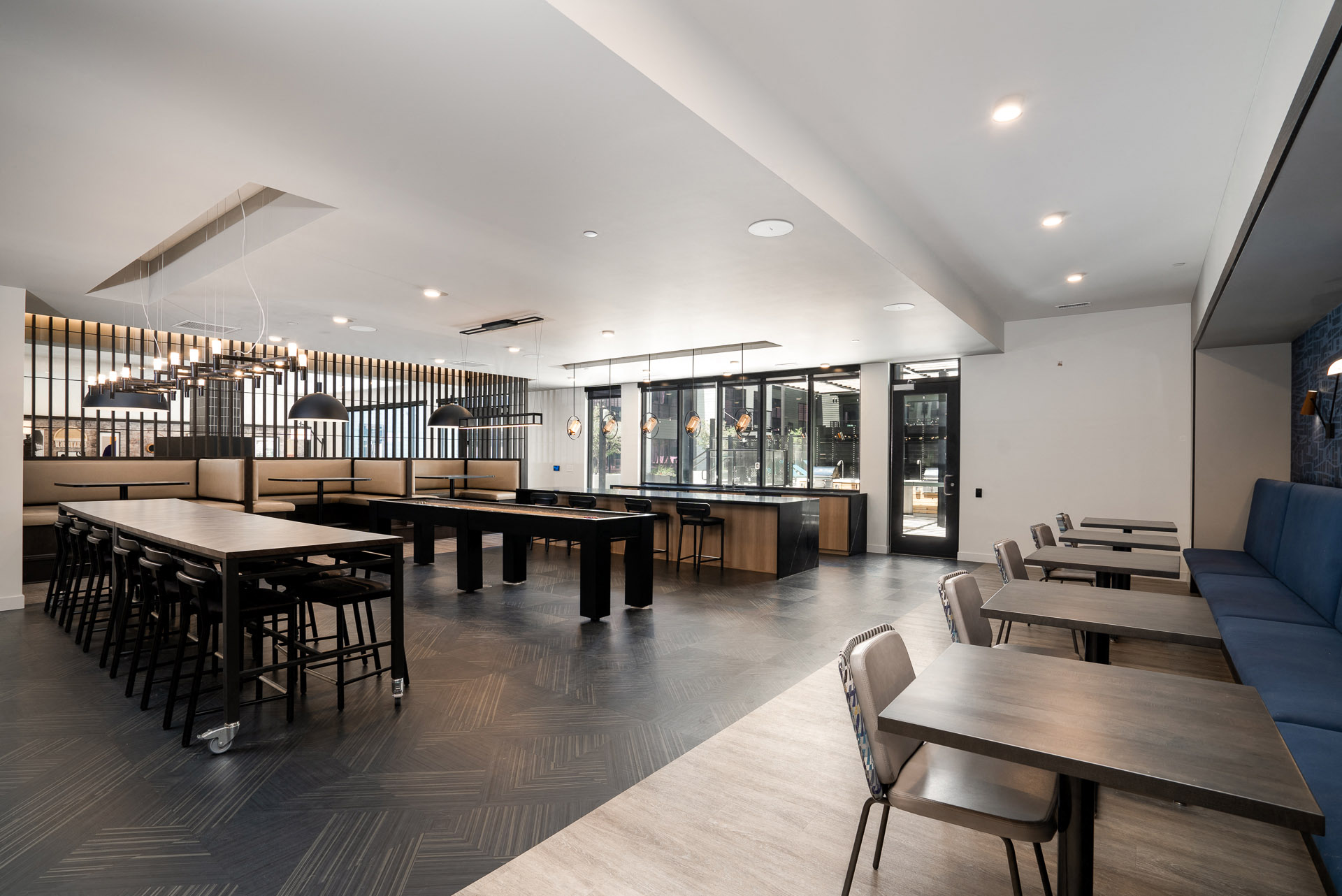 Rec room with a variety of seating and lighting and a banquette