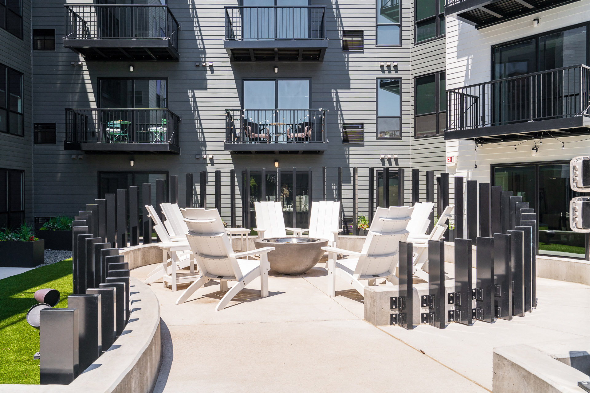 Outdoor fireplace surrounded by chairs
