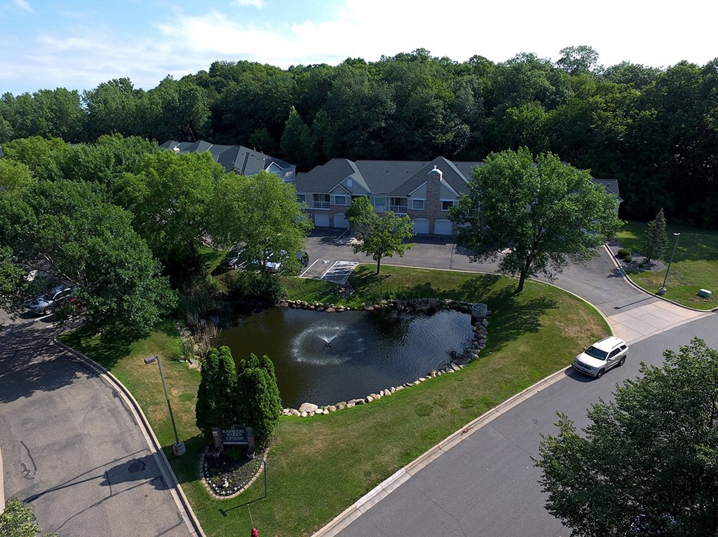 a house with a pond in front of it