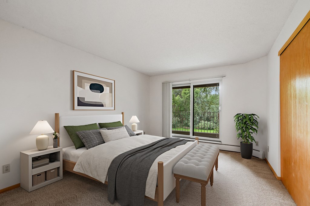 a bedroom with a bed and a large window