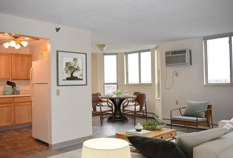 A living room with a dining table and chairs.
