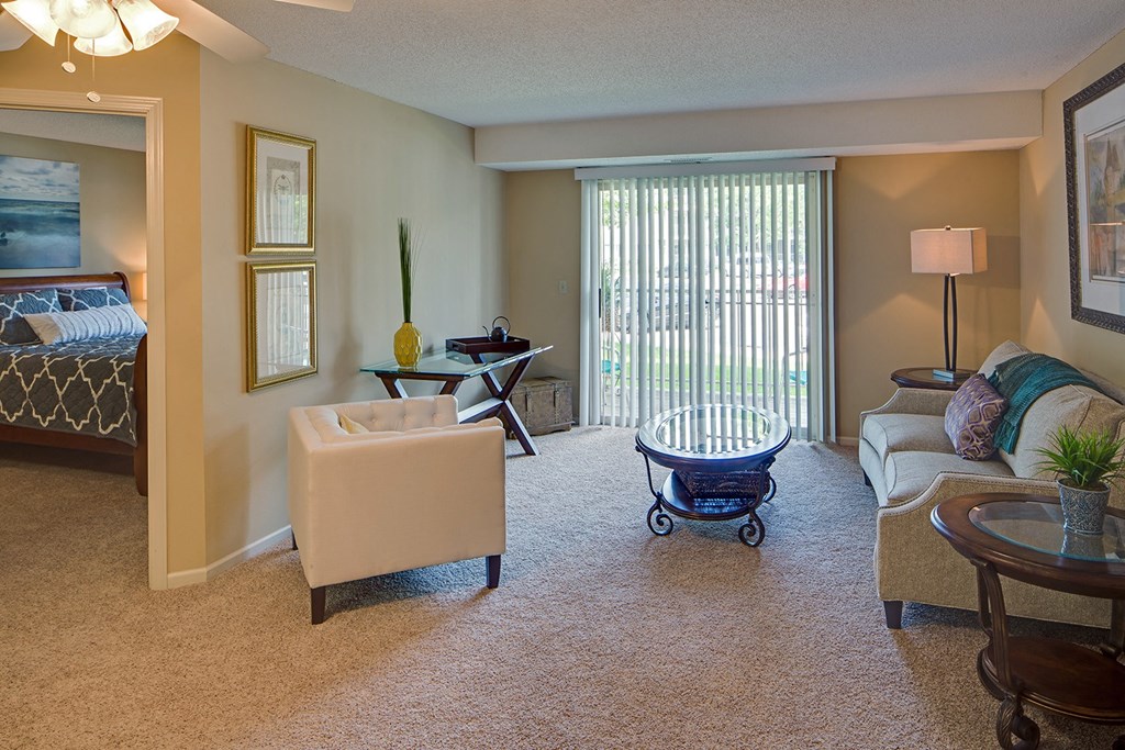a living room with a couch and a chair and a table