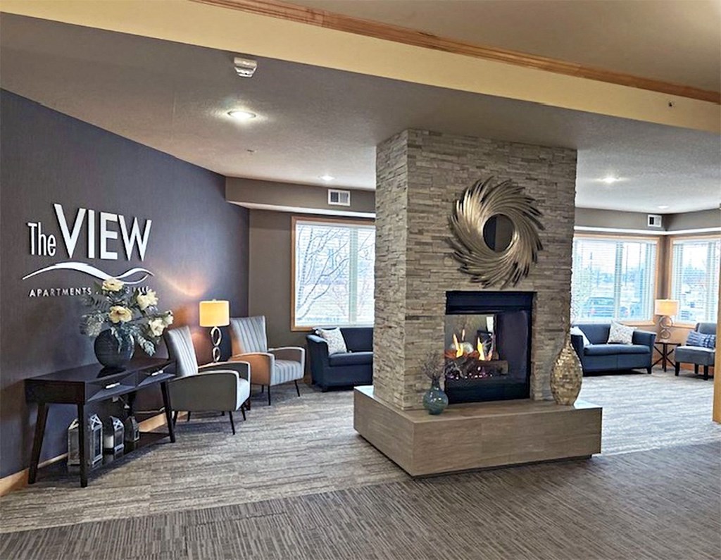 a living room with a fireplace and a table with chairs