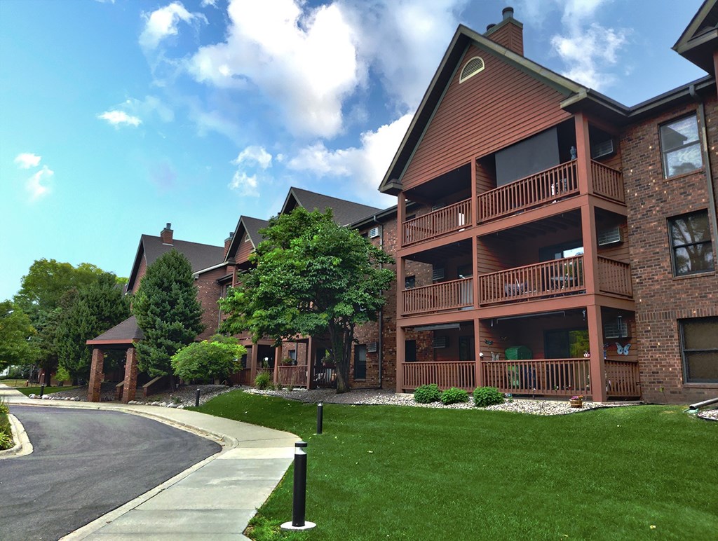 a large brick building with trees in the background