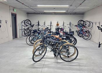 a bunch of bikes parked in a room with other bikes