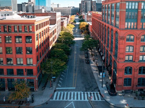 A street view of a city with red buildings on either side.