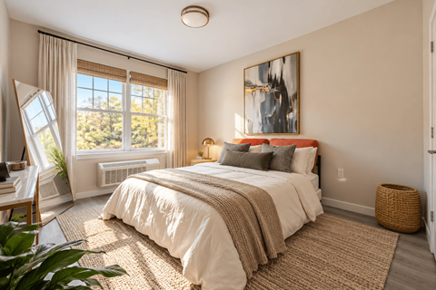 A bedroom with a large bed and a painting on the wall.