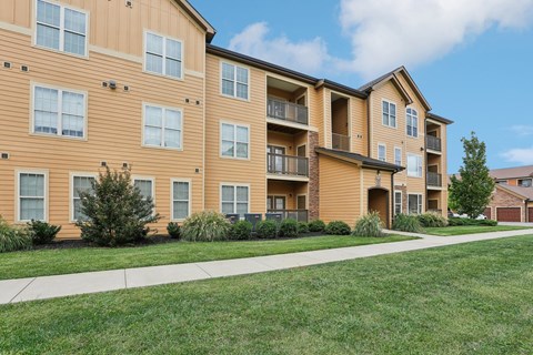 Apartment building with a grassy area in front.