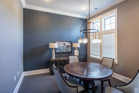 A dining room with a wooden table and chairs.