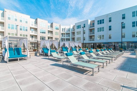 A sunny day at the outdoor pool area of a residential building.