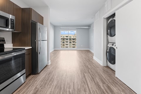 A modern kitchen with wooden cabinets and stainless steel appliances.