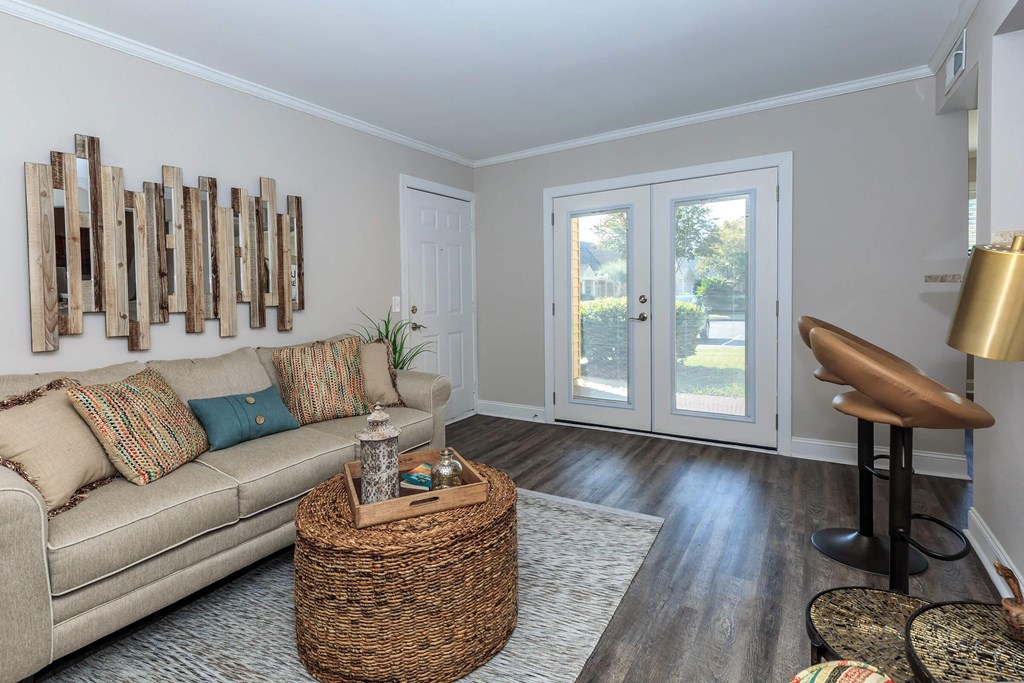 a living room with a couch and a door to a patio at Sawgrass Apartments, Charleston, South Carolina
