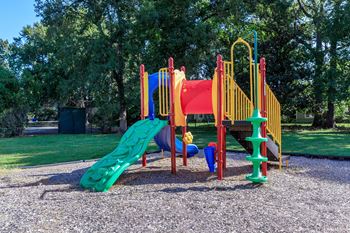 a playground with a slide and other toys in a park at Sawgrass Apartments, Charleston, SC