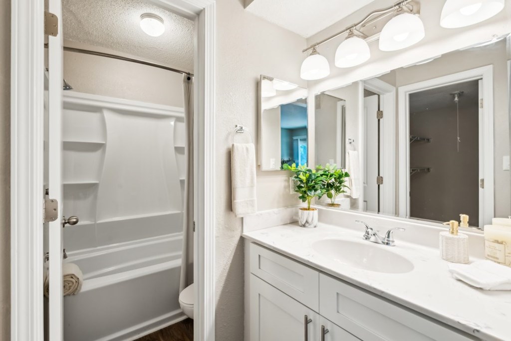 A white bathroom with a white sink and a white towel. at Woodcreek Apartments, North Carolina