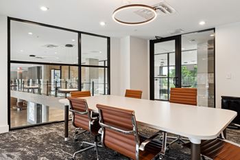 a conference room with a white table and chairs at Hydro, Richmond, VA