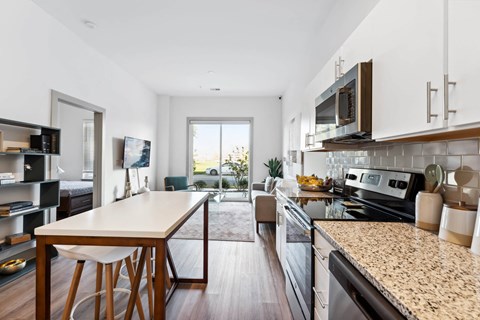 A modern kitchen with a wooden table and chairs.