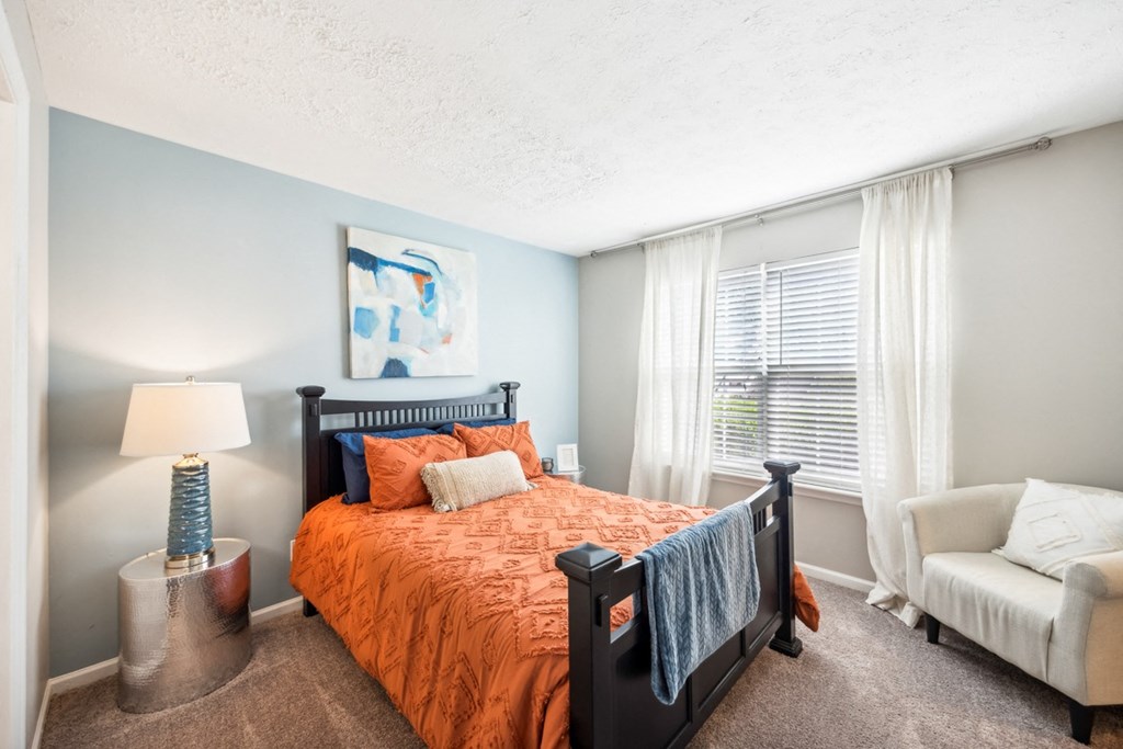the preserve at ballantyne commons apartment bedroom with bed and chair at River Oak Apartments, Louisville, 40206