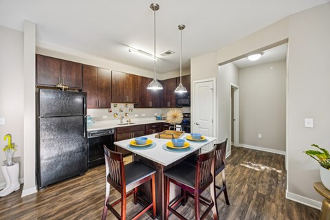 A kitchen with a table set for two.