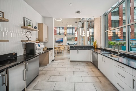 A modern kitchen with a black countertop and white cabinets. at The Locks, Richmond