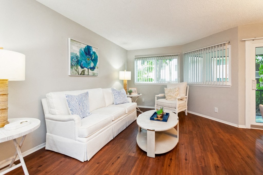 a living room with a white couch and a coffee table