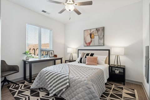 a bedroom with a large bed and a ceiling fan at The Constellation Apartments, PRG Real Estate, Hampton, Virginia