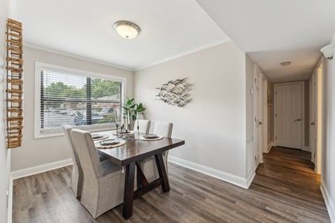 A dining room with a table and chairs at Sawgrass Apartments, South Carolina