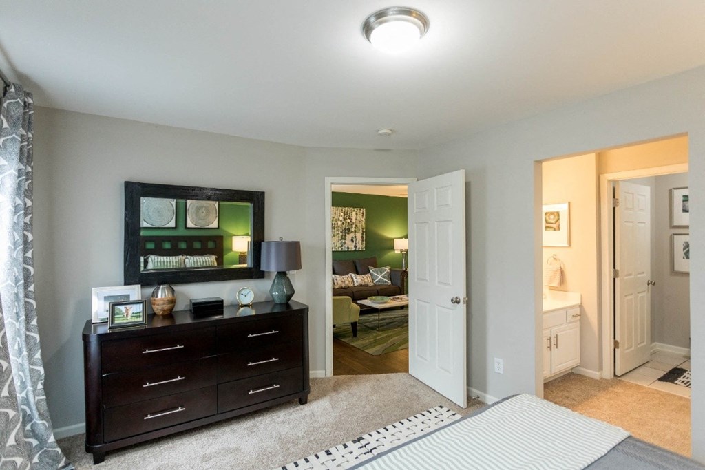 a bedroom with a dresser and mirror at The Resort At Lake Crossing Apartments, PRG Real Estate, Lexington, KY