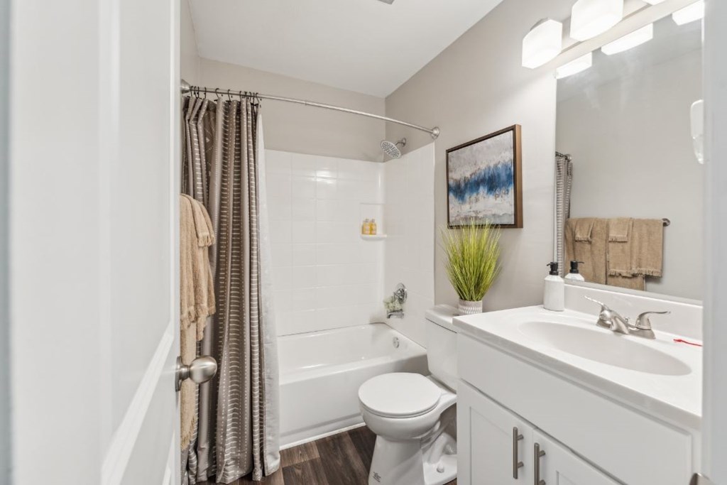 A bathroom with a toilet, sink, and shower at Staples Mill Townhomes Apartments, Richmond, Virginia
