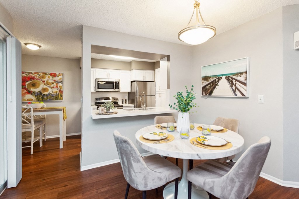 an open kitchen and dining room with a table and chairs