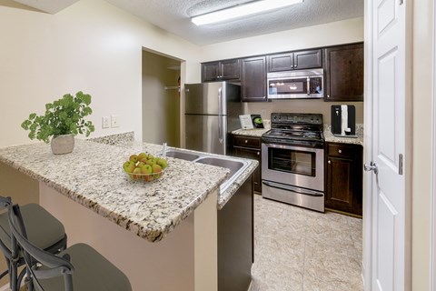 Kitchen with granite countertops and stainless steel appliances at Herons Point, Virginia Beach, 23451