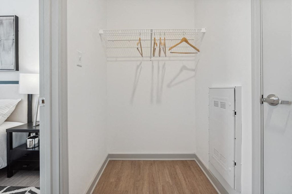 a bedroom with a white walls and a wooden floor at The Constellation Apartments, PRG Real Estate, Hampton, Virginia