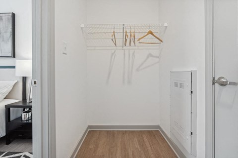 a bedroom with a white walls and a wooden floor at The Constellation Apartments, PRG Real Estate, Hampton, Virginia